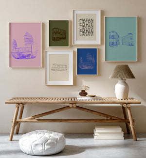 Colorful art prints framed and displayed on a beige interior wall.