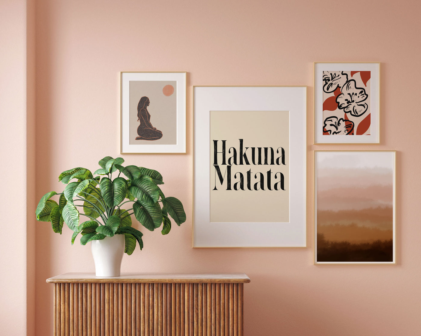 Interior pink wall with four framed art prints on display.